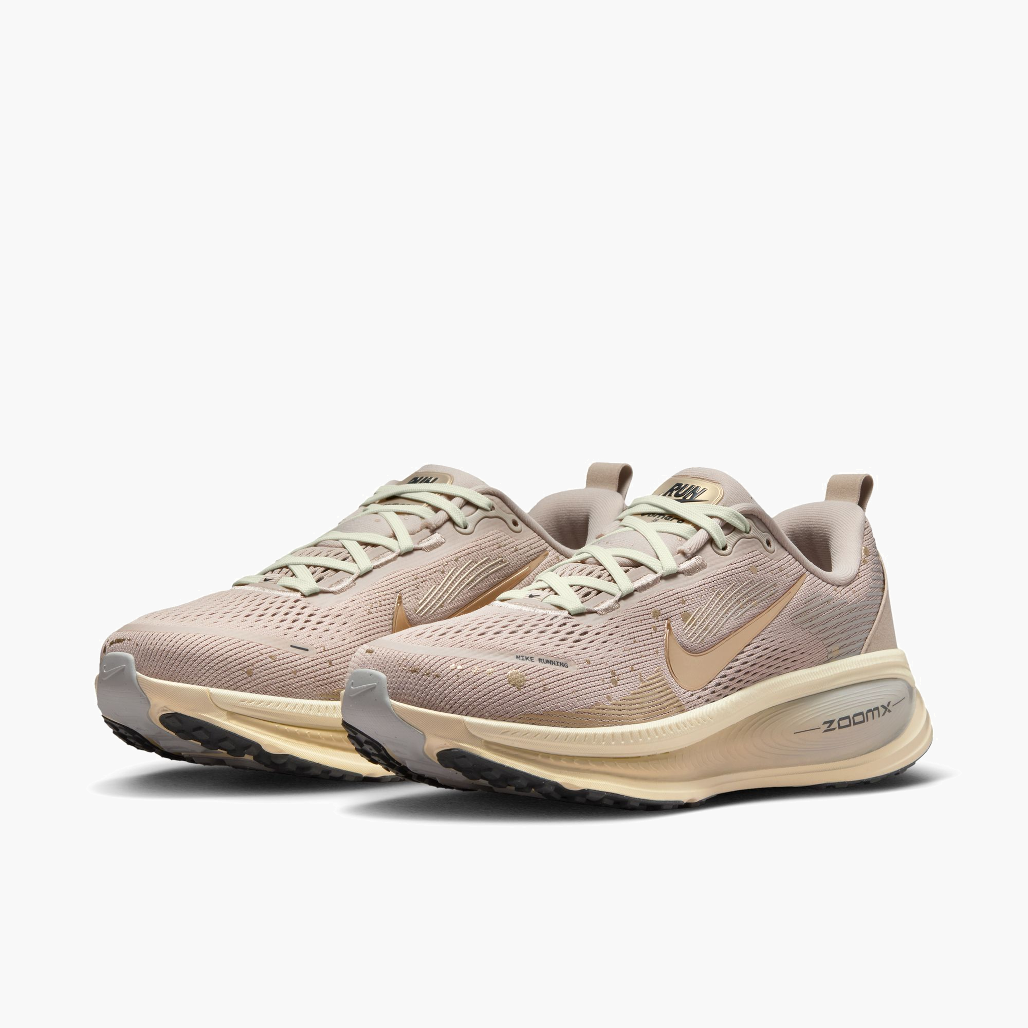 3/4 angle shot of Women's Vomero 18 in Cream Ii / Mtlc Gold Grain-Coconut Milk