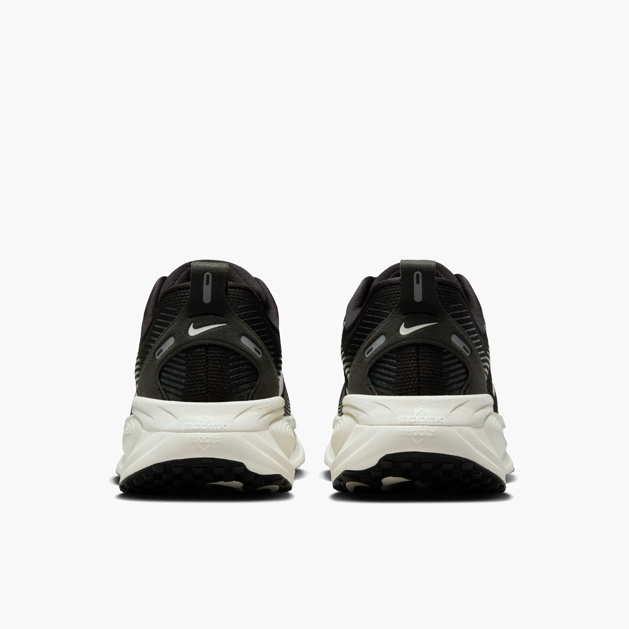 Heel angle shot of Women's Vomero 18 in Black / Summit White-Coconut Milk