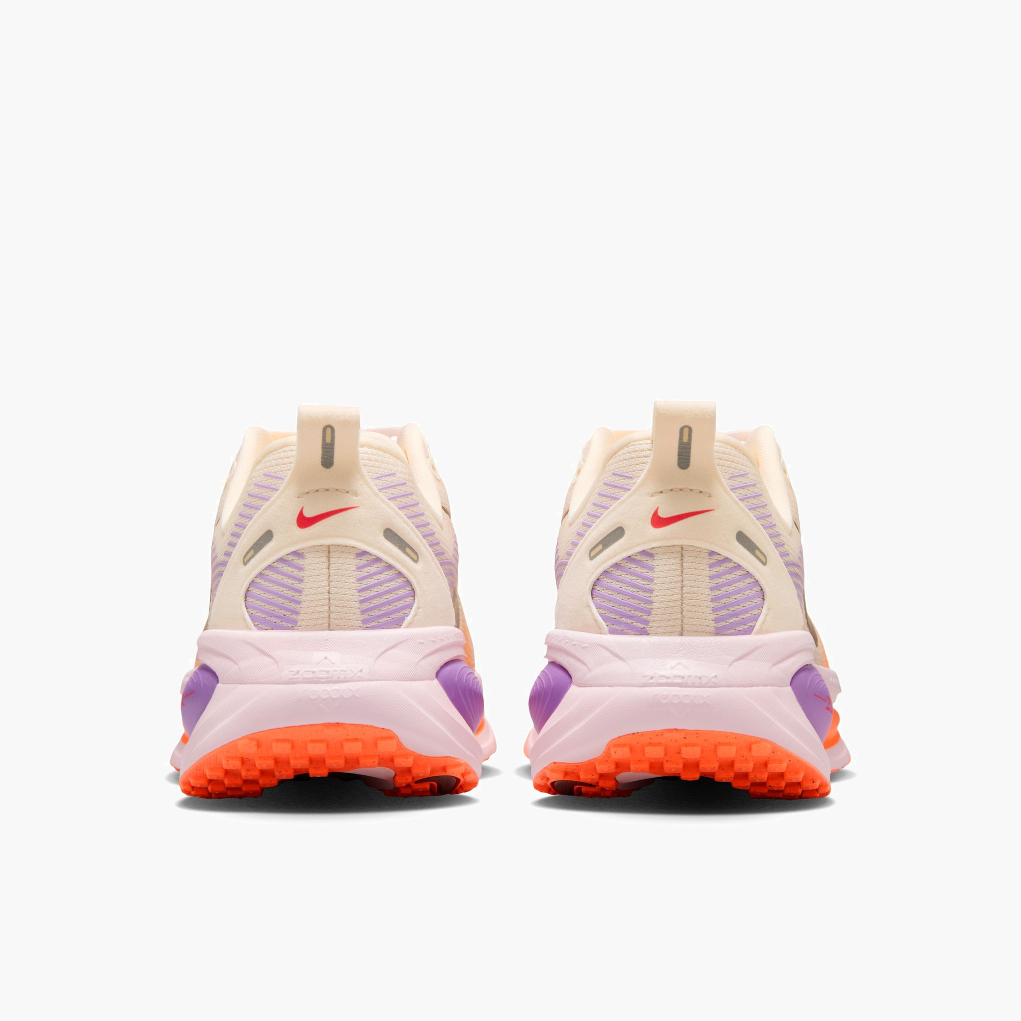 Heel angle shot of Women's Vomero 18 in Chalk / Tattoo-Pink Foam-Bright Violet