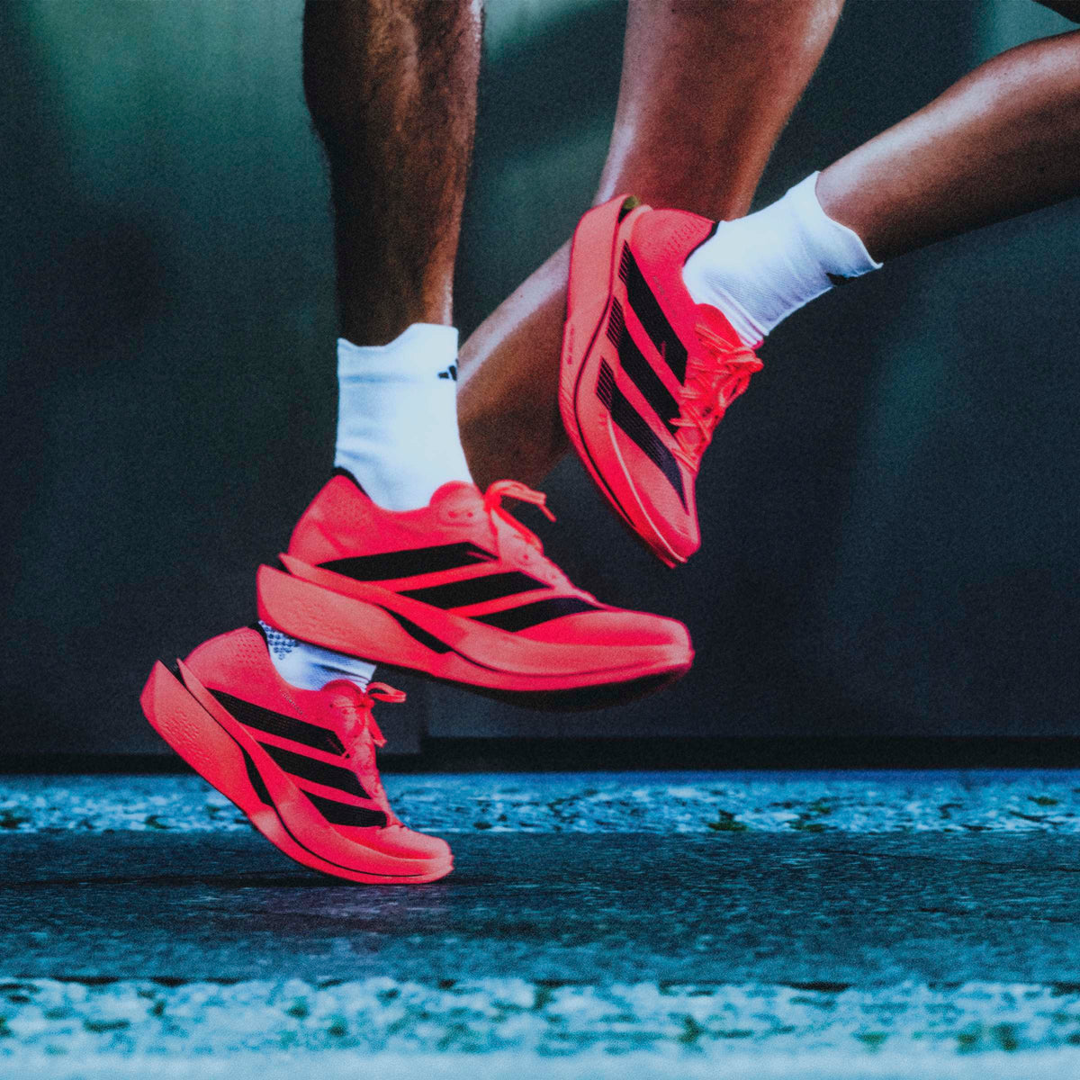 Runners wearing the adidas Adizero Adios Pro 5 in Solar Turbo