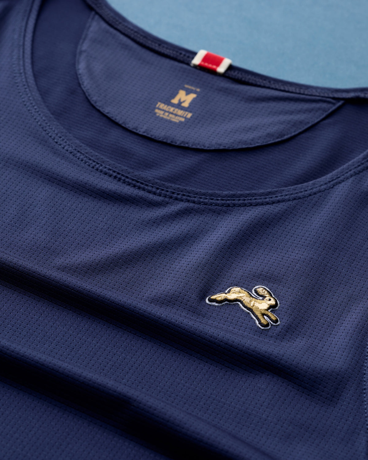 Tracksmith Twilight micro-mesh fabric and embroidered hare detail