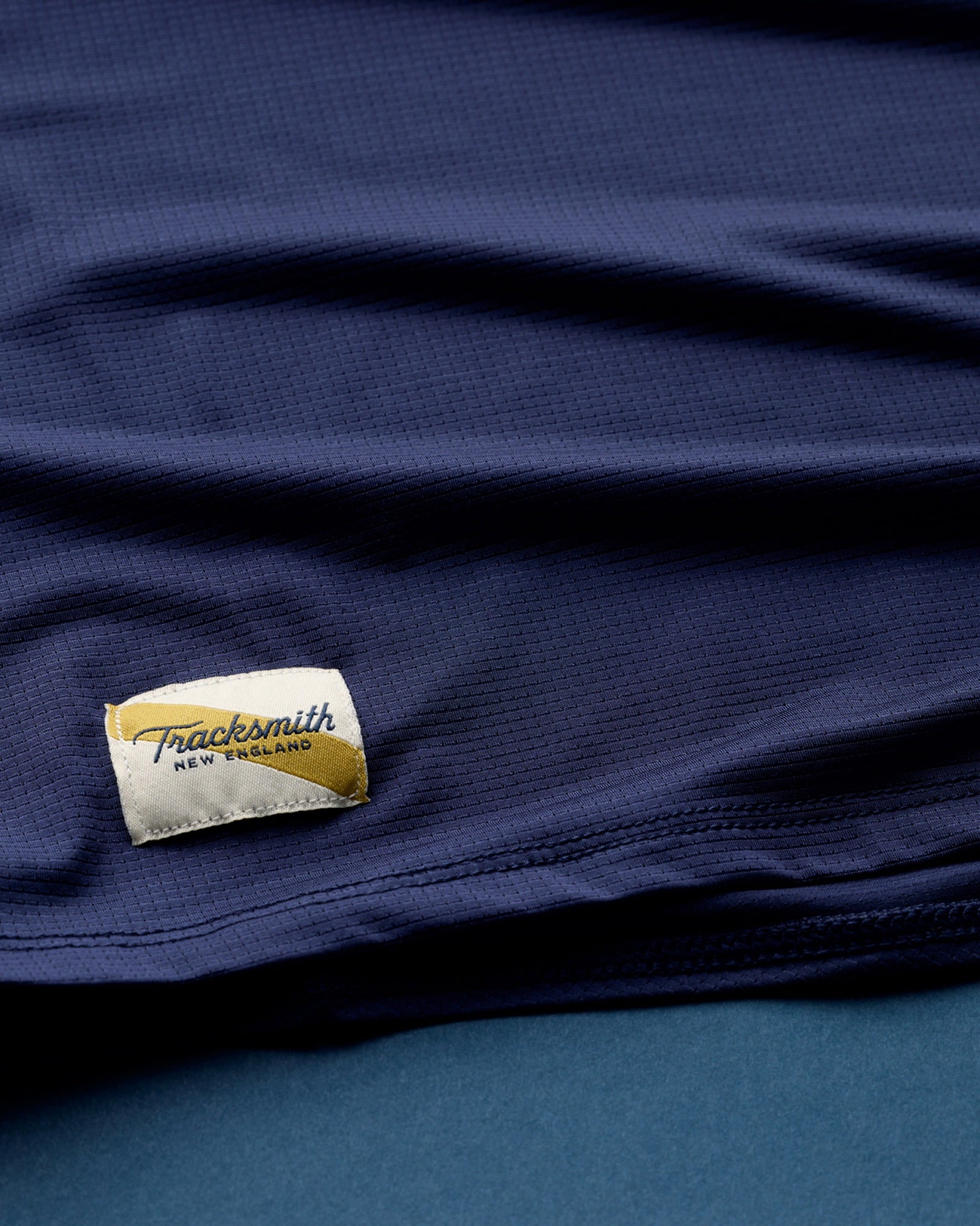 Neckline and trim detail on a Tracksmith Twilight top