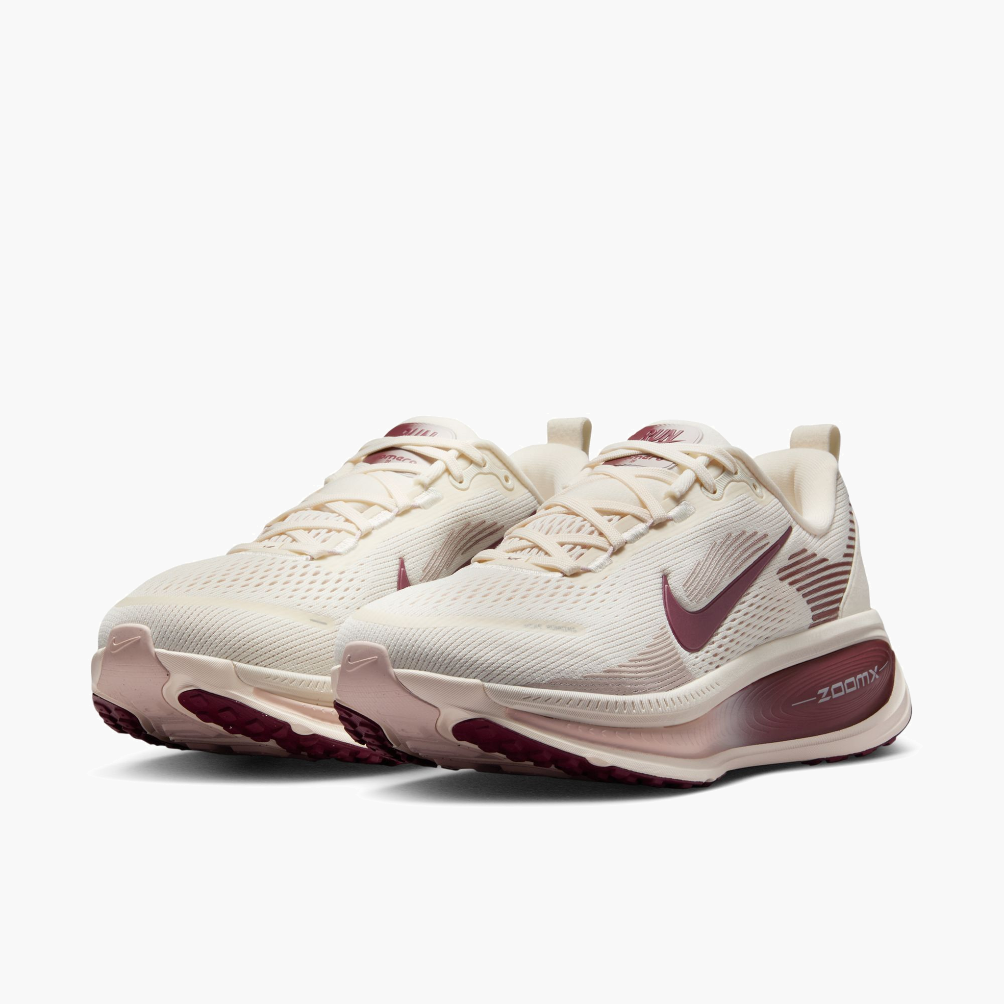 3/4 angle shot of Women's Vomero 18 in Pale Ivory / Dark Team Red-Red Sepia