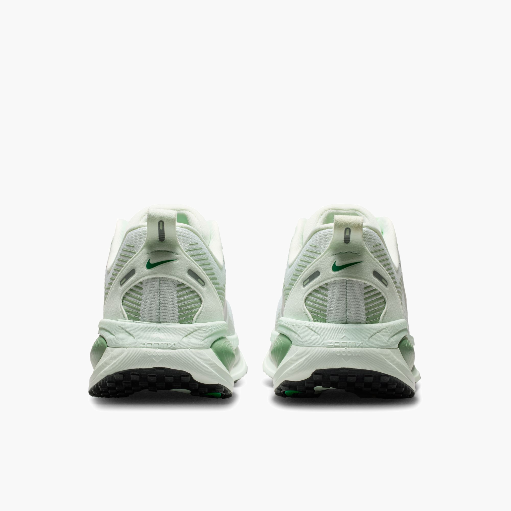 Heel angle shot of Women's Vomero 18 in Barely Green / Metallic Silver-Steam
