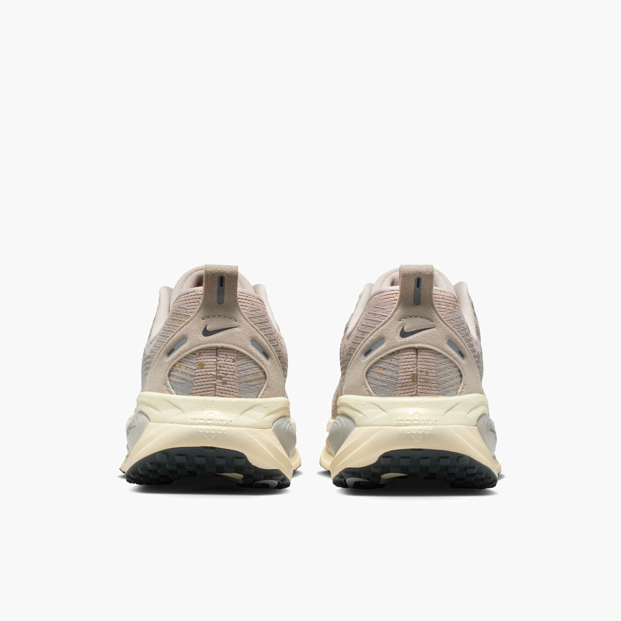 Heel angle shot of Women's Vomero 18 in Cream Ii / Mtlc Gold Grain-Coconut Milk