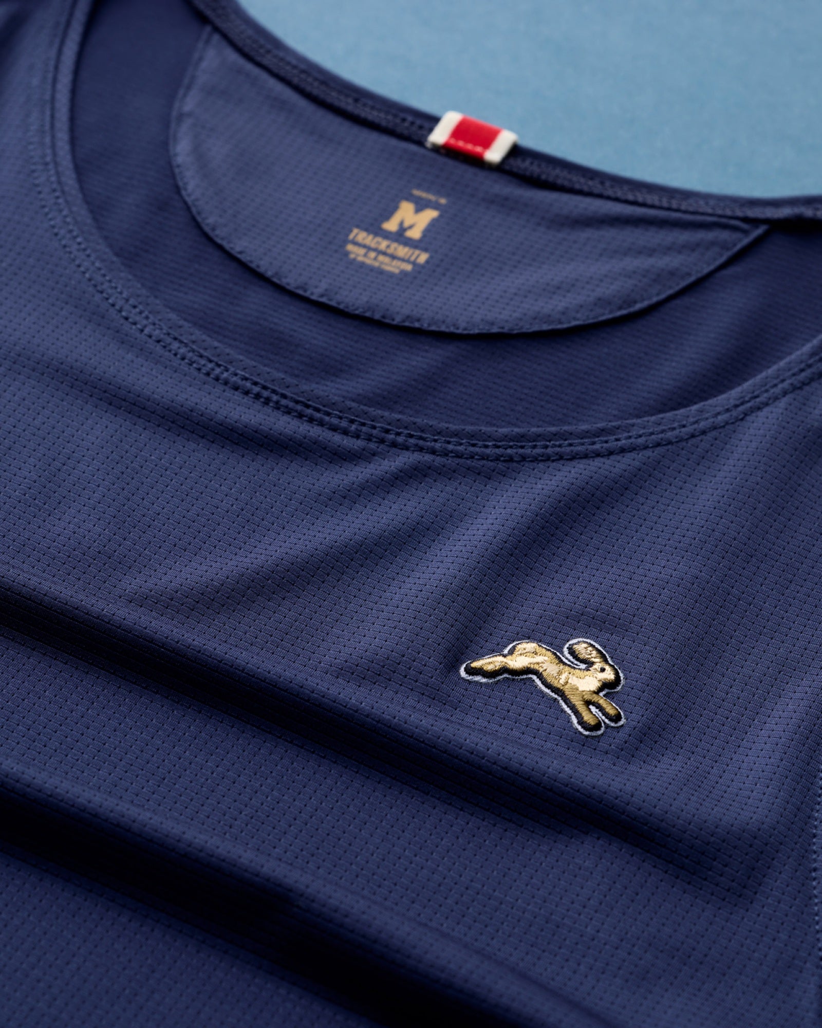 Tracksmith Twilight micro-mesh fabric and embroidered hare detail