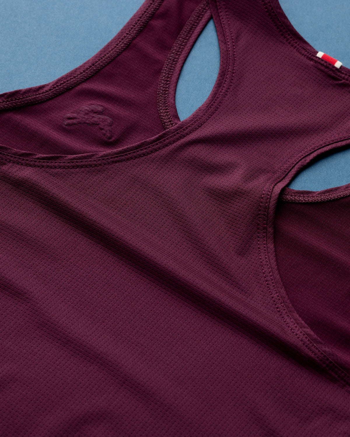 Reinforced double-stitched seam detail on the Tracksmith Twilight Crop Tank